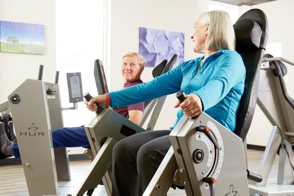 Senior adults performing strength training exercises on HUR equipment for healthy aging and brain health