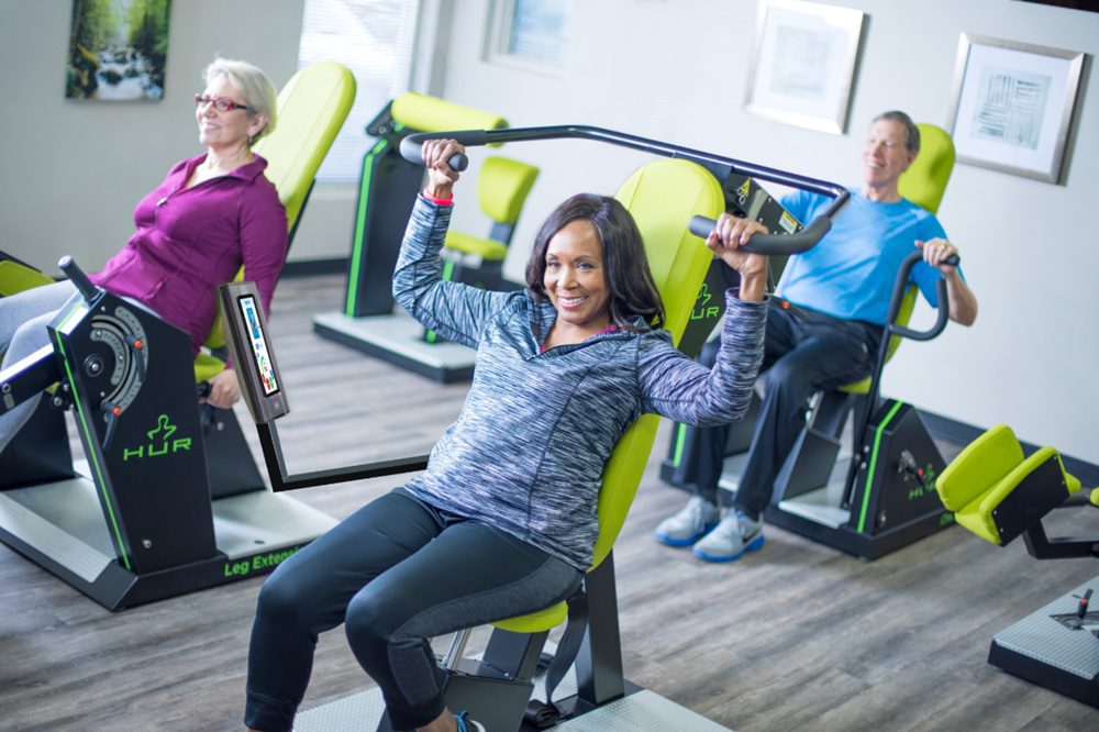 Older adults participating in a progressive strength training program that supports brain health and cognitive wellness.