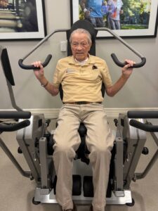 Plymouth Place resident exercising on HUR strength training equipment