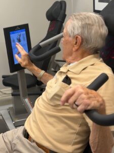 Plymouth Place resident using HUR SmartTouch equipment with an interactive touchscreen